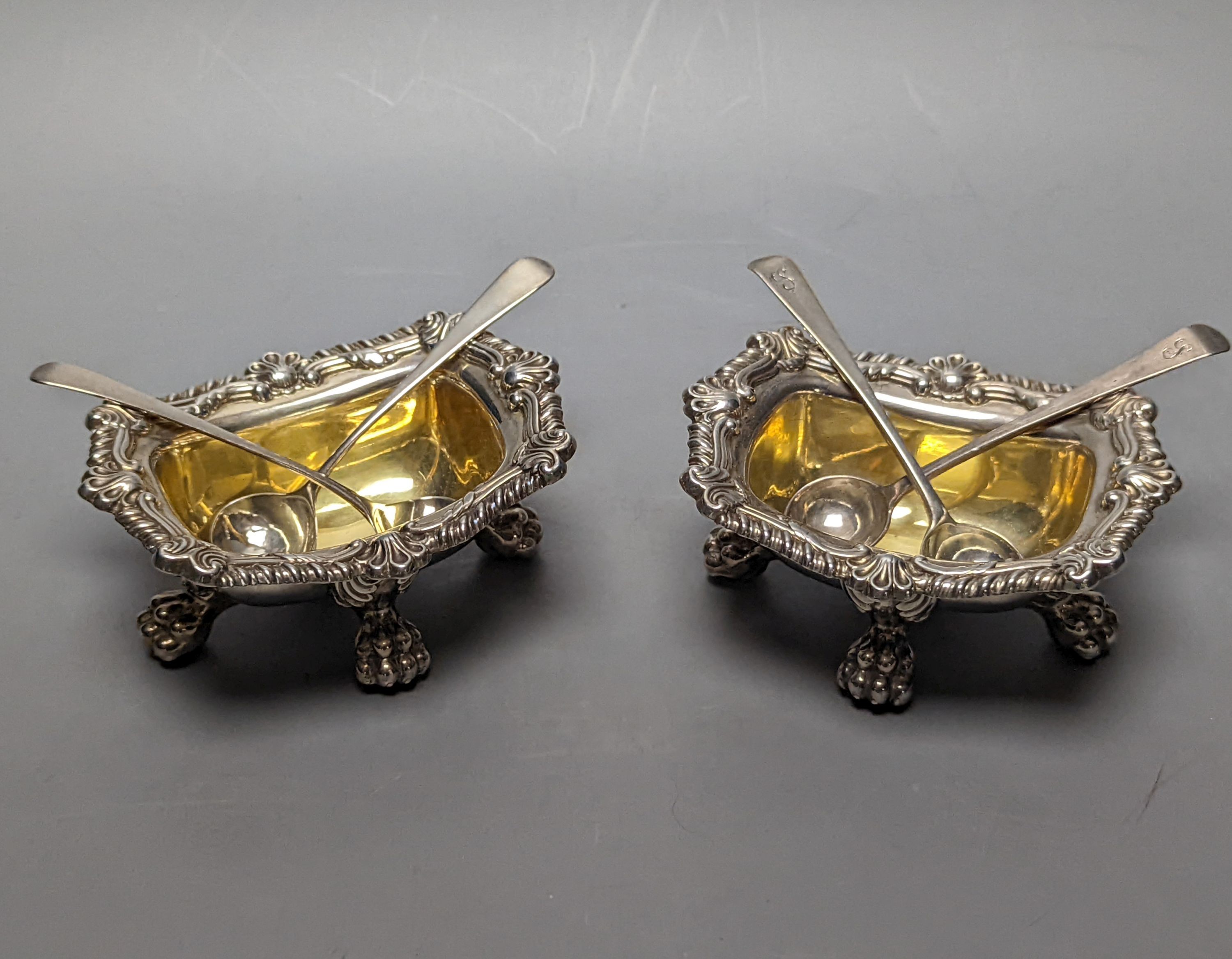 A pair of George III silver salts, with lion's paw feet, S.C.Younge & Co, Sheffield, 1817, 10.6cm, together with two pairs of associated George III silver condiment spoons